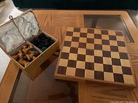 Wooden chess board and storage box with chess pieces packed inside, showing condition and included items