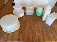 Photo of all food storage containers and cake carrier arranged on floor