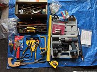 Overall view of lot showing toolboxes with various hand tools, Ryobi drill kit with case, measuring tape and small saw