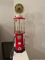 Full view of the Musgo novelty beverage dispenser resembling vintage gas pump with Musgo gasoline label and measurement markings