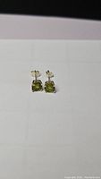Front view of Peridot apple green stud earrings on plain background showing size and shape.