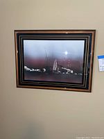 Front view of one of the abstract framed art prints showing black and reddish abstract design with black and gold matting and wooden frame.