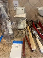 Photo of Hamilton Beach food processor with accessories and cooking utensils displayed on countertop
