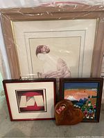Overview of all four wall art pieces: three framed prints and one wooden heart-shaped hanging.
