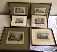Full view of all six framed engravings, etchings and bookplate on white cloth.