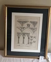 Front view of framed architectural book plate with detailed lithographic sketches in black and white, gold-tone frame with matting.