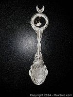 Full view of the Harley-Davidson Christmas 2003 pewter collector spoon showing wreath, bell, braided handle and brand shield