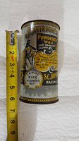 Full view of the antique lithographed tin can with ruler showing approximate height of 5.5 inches.