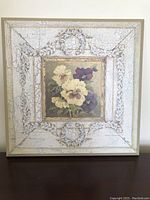 Square decorative wood art with cream and purple pansy painting, crackled off-white ornate border