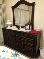 Full view of the cherrywood triple dresser and matching large framed mirror with decorative molding. Shows overall condition and styling.