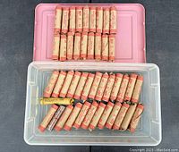 Top view showing eleven sealed rolls of Canadian pennies wrapped in brown paper, with red print indicating value and bank wrapping details.