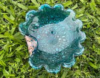 Top view of vintage Murano turquoise glass bowl showing scalloped edge and amber accent rim section.