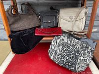 Overview photo showing all six bags arranged on a table, displaying variety of styles, colors and materials.