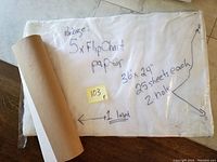 Flip chart paper pads stacked with handwritten label describing 5 blank sheets, 25 sheets each, 2-hole and 1 lined pad, size 36x24 inches.