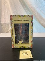 Box of the Ace Gift Collection Energy Efficient Touch Lamp showing front panel with product name, colorful design, and LED bulb included note.