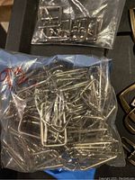 Bag of silver rectangular buckles on black surface