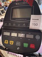 Close-up of the electronic console with display screen and control buttons including start, reset, up/down adjustment, showing brand Diamondback.