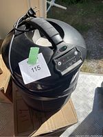 Photo of black cylindrical FilterQueen air purifier unit showing top handle, control panel, and power cord.