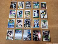 Photo showing a variety of baseball cards laid out on table, many in sleeves.