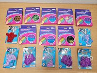 Top-down view of the lot showing five Infinity Pop Bubble multi-color sensory toy packs and ten assorted pop fidget keychain toys in various colors and shapes.