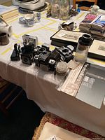 Wide view of multiple cameras and equipment on table