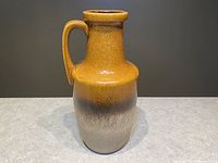 Front view of the jug showing the gradient glaze and handle.