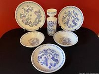 Six-piece vintage FIGGJO Norway pottery set including three plates, two bowls, and a candle holder with classic Lotte Turi blue and purple designs on white base.