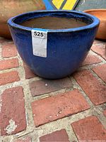 Front view of large blue glazed earthenware planter with label showing lot number and measurements.