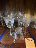 Front view of multiple etched glass water goblets with floral Morning Glory pattern.