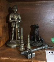 Full set with knight lighter, mouthpieces, dog figurine and key displayed on shelf