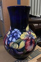 Front profile of Moorcroft vase showing full body and floral motif.