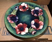 Front view of Moorcroft plate showing floral design and overall shape