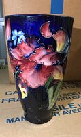 Front view showing pink and red orchid design on cobalt blue ground