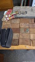 Antique postcards including leather patchwork postcard and multiple paper postcards with various writing and images