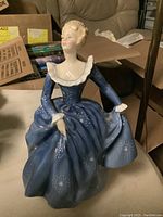 Front angled view of Royal Doulton figurine showing detailed dress and facial expression.