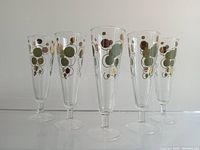 Photo showing all five champagne flutes with bubble/polka dot pattern arranged in a line