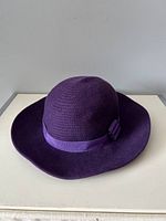 Purple vintage hat front angle showing textured crown, fabric band and bow detail