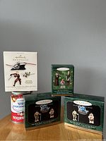 Photo of four Mini Hallmark Keepsake Star Wars Christmas ornament boxes, displayed with a soda can for scale, showing original packaging and artwork of the characters included.