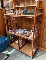 Front angled view showing bamboo frame and woven shelves with lattice sides