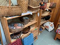 Two wooden bookcases shown side by side filled with baskets and decorative bowls, no back panel visible.