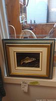 Framed acrylic painting on board showing detailed fish artwork signed by Lyle Dobrino, framed in a decorative multi-toned frame
