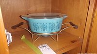 Full set: turquoise Pyrex casserole dish in brass-tone stand with lid on