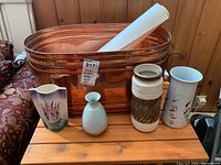 Photo showing all four ceramic vases, the large copper metal broiler and the rolled poster inside the broiler.