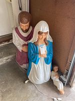 Full view of Mary and Joseph figures kneeling, with Baby Jesus figure lying on ground in front of them. Shows overall size and painted details.