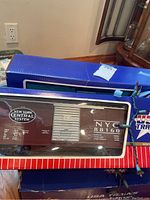Close-up of brown New York Central System model train boxcar in display box marked NYC 88160