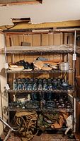 Metal wire storage rack holding various items in a basement setting.