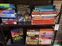 Photo of stacked vintage role playing and war themed tabletop games showing titles and boxes.