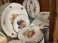 Photo showing six Arzberg fruit plates stacked with visible fruit and gold trim