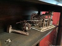 Wooden mechanical models on shelf with helicopter and marble parkour visible