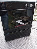 Full front angled view of the Asept-Air Life-cell 2550 HEPA air purifier showing black glossy finish with some scratches and button controls.